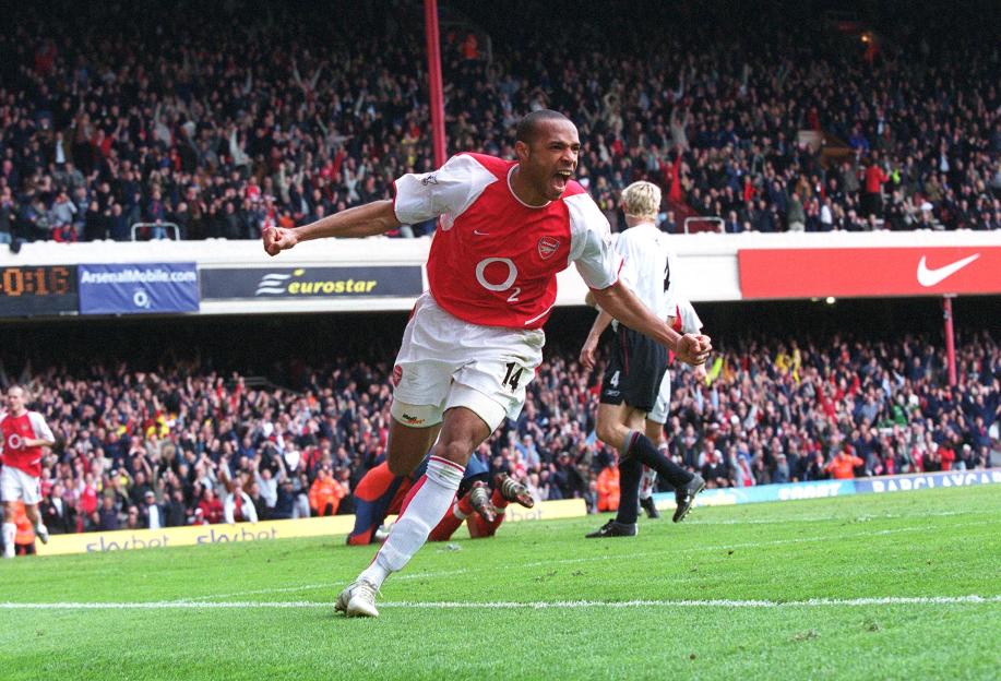 Thierry Henry celebrating his second goal during a Premier League match between Arsenal and Liverpool.