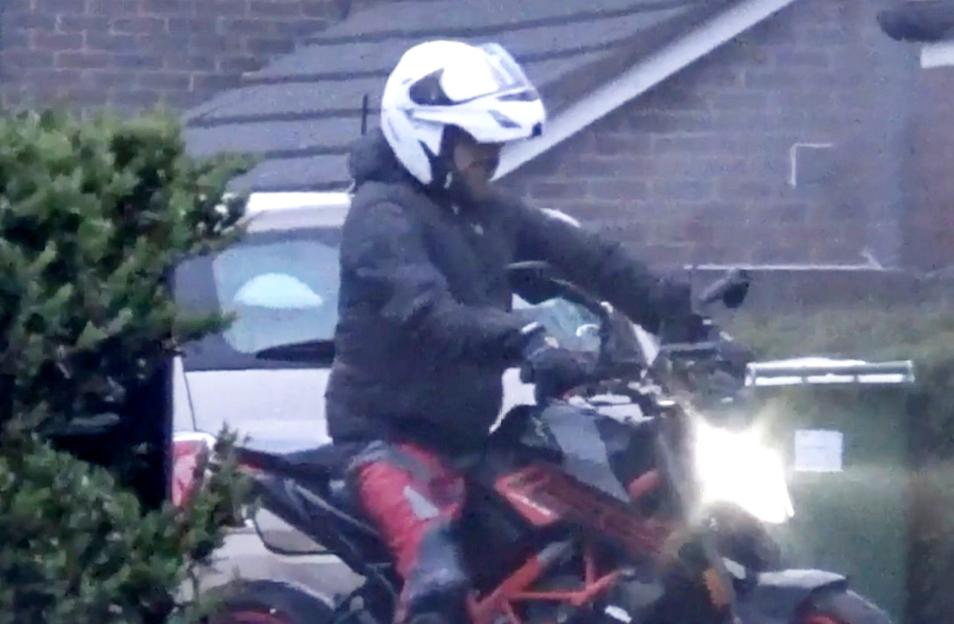 Tony Rose, 32, wearing a white helmet and black jacket, riding a motorbike.