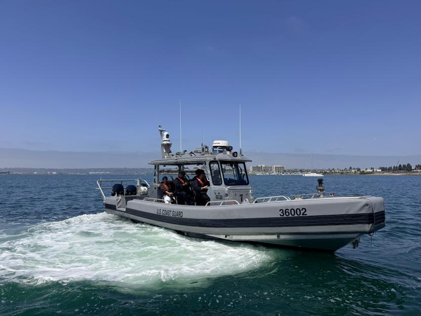 A US Coast Guard boat skims across the San Diego Bay, demonstrating how they intercept migrants.