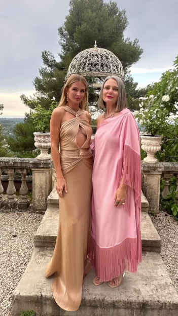 Millie Mackintosh (left) in a gold dress with her manager and friend in a pink dress.