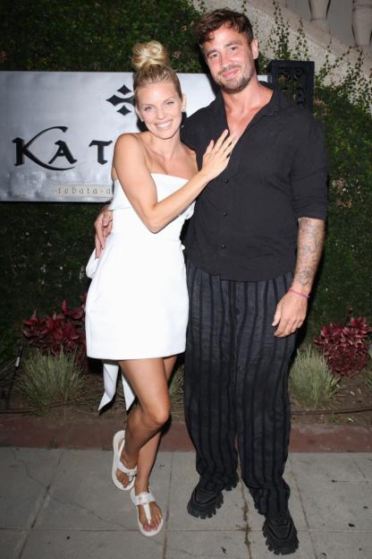 AnnaLynne McCord and Danny Cipriani pose together in front of the Katana restaurant sign.