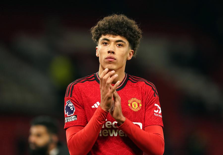 Ethan Wheatley applauding the fans in his red Manchester United jersey.