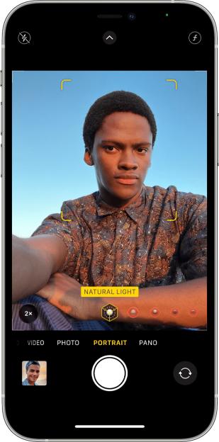 A smartphone displaying a portrait mode selfie of a man.