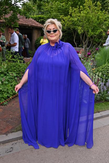 Gemma Collins attends the RHS Chelsea Flower Show 2025 in a blue dress and sunglasses.