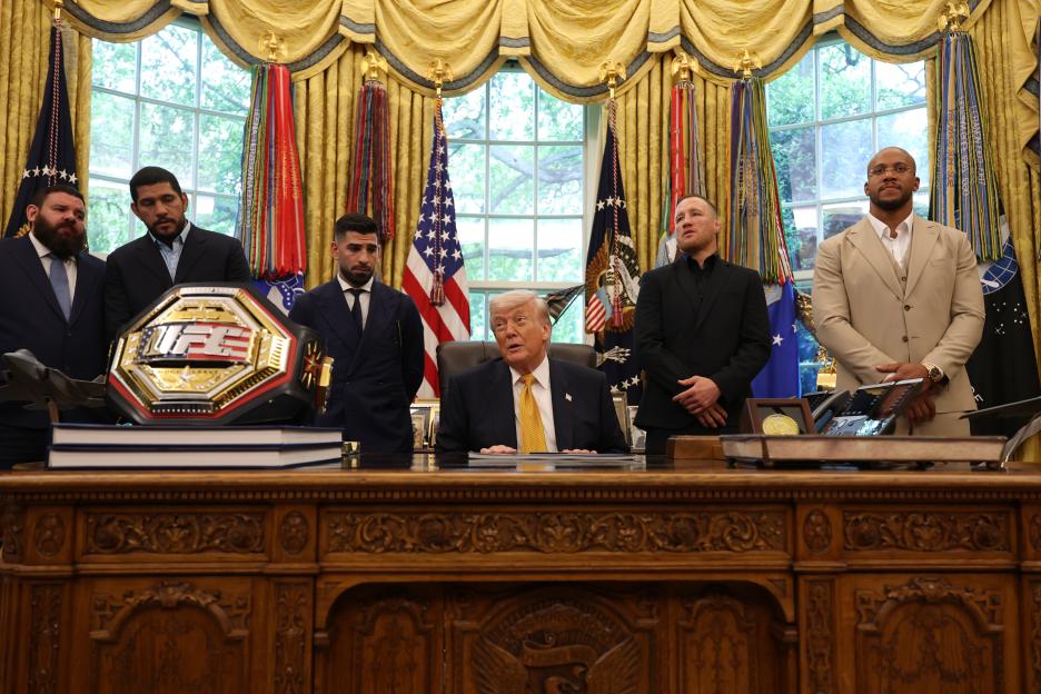 President Trump sits at his desk in the Oval Office with UFC fighters Ilia Topuria, Alex Pereira, Justin Gaethje, and Ciryl Gane.