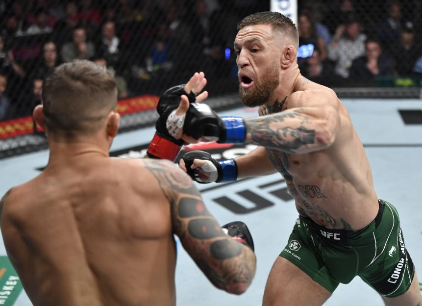 Conor McGregor of Ireland punches Dustin Poirier during a welterweight fight.