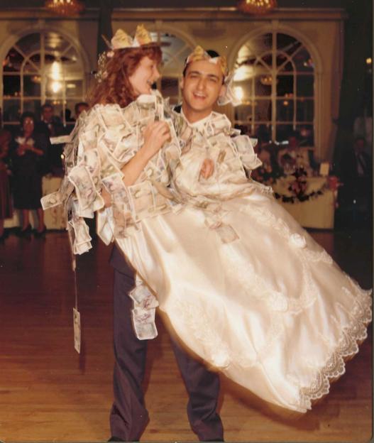 Gilly and John on their wedding day in 1989, with money bills pinned to their clothes.