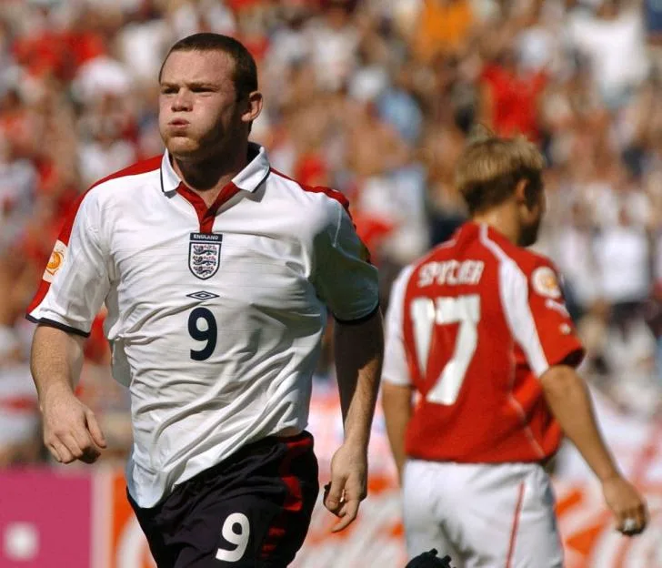 England's Wayne Rooney reacts after scoring a goal against Switzerland's Christoph Spycher.
