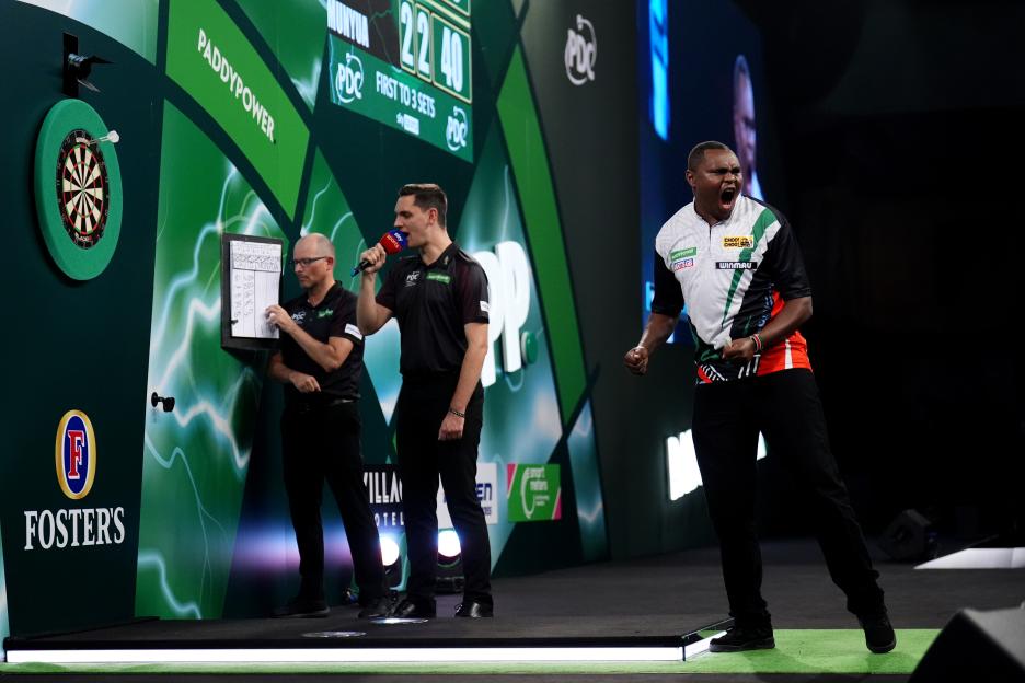 David Munyua celebrates his victory over Mike De Decker at the Paddy Power World Darts Championship.