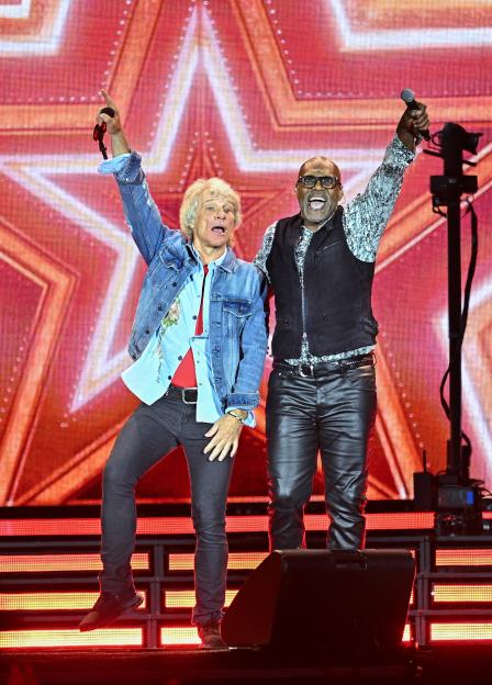 Jon Bon Jovi and Everett Bradley performing on stage.