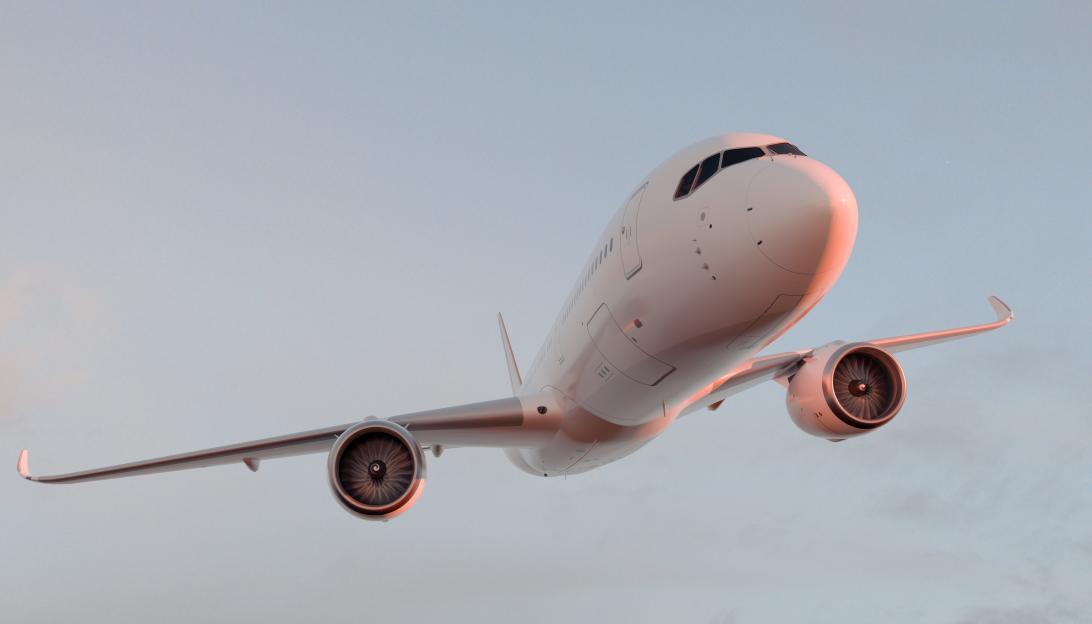 Commercial airplane flying up in clear sky during sunset