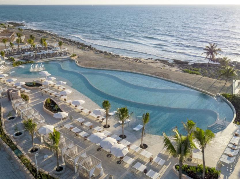 Aerial view of the Essence at the Fives Beach hotel and TRS Yucatan hotel pool area and beach.