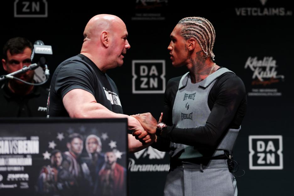 Dana White and Conor Benn shake hands at a press conference.