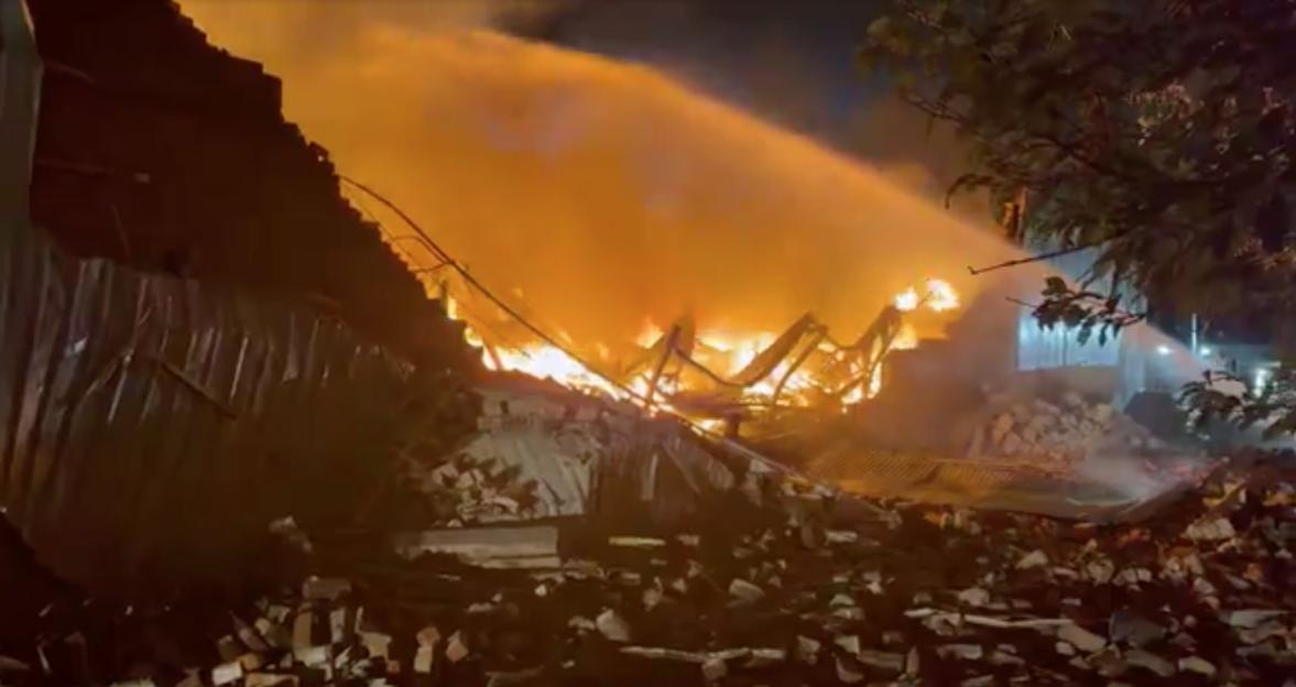 Firefighters extinguish a huge fire at a commercial building on Bury New Road in Salford.