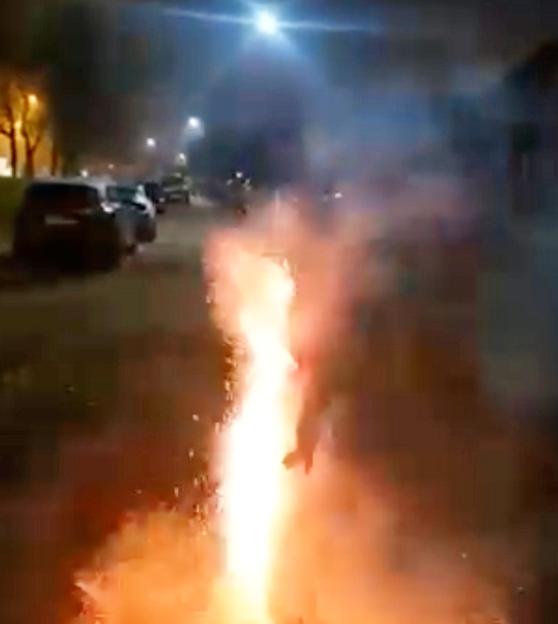 Fireworks exploding from between a man's buttocks, causing burns.