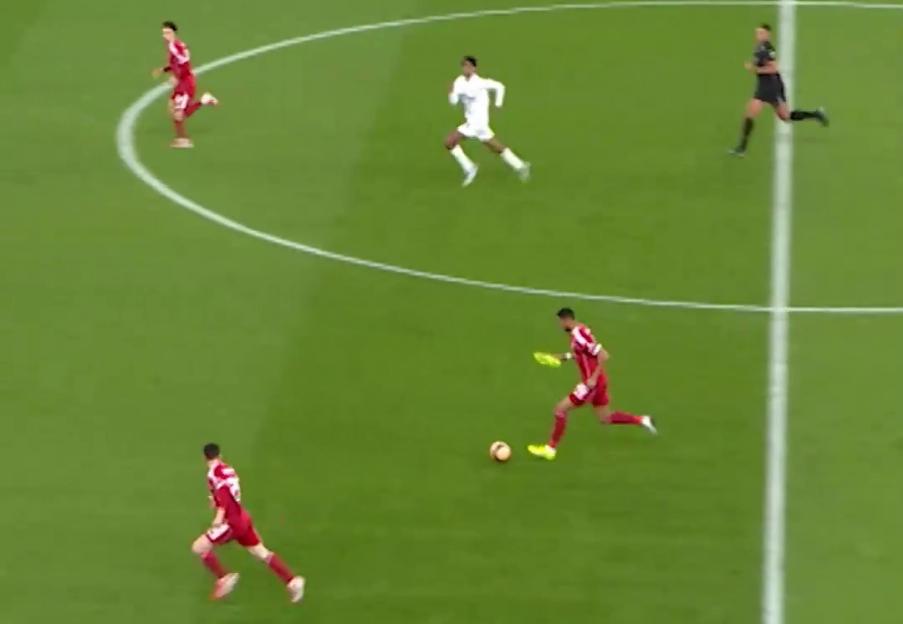 Cody Gakpo playing soccer in one boot for Liverpool.