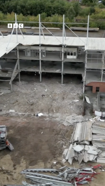 Demolished building with debris on the ground.