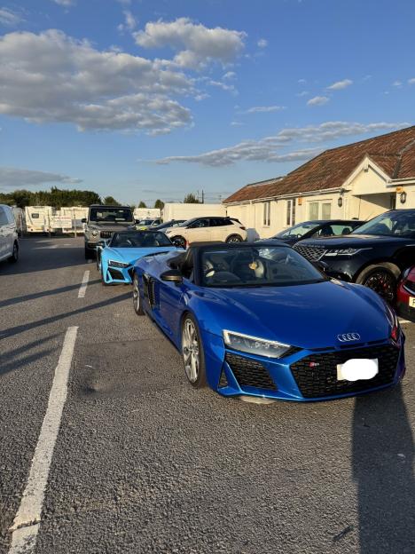 Seized blue and turquoise supercars parked in a lot.