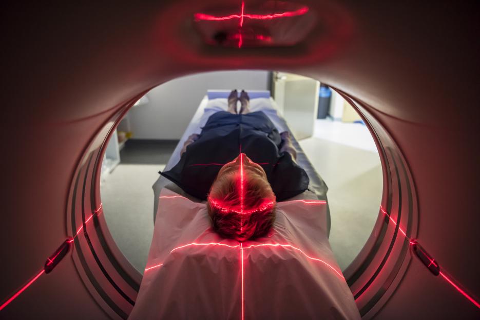 Person undergoing a CAT scan in a hospital.