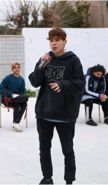 Ezequiel David Pereyra speaking into a microphone.