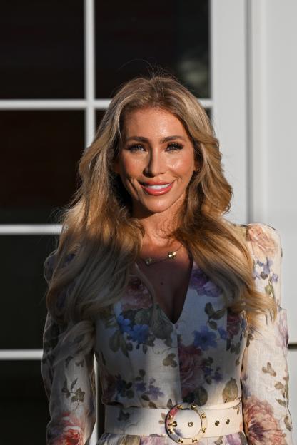 Melissa Rein Lively wearing a floral dress.