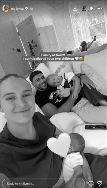Molly-Mae Hague breastfeeds her newborn baby while Tommy Fury holds their older child.