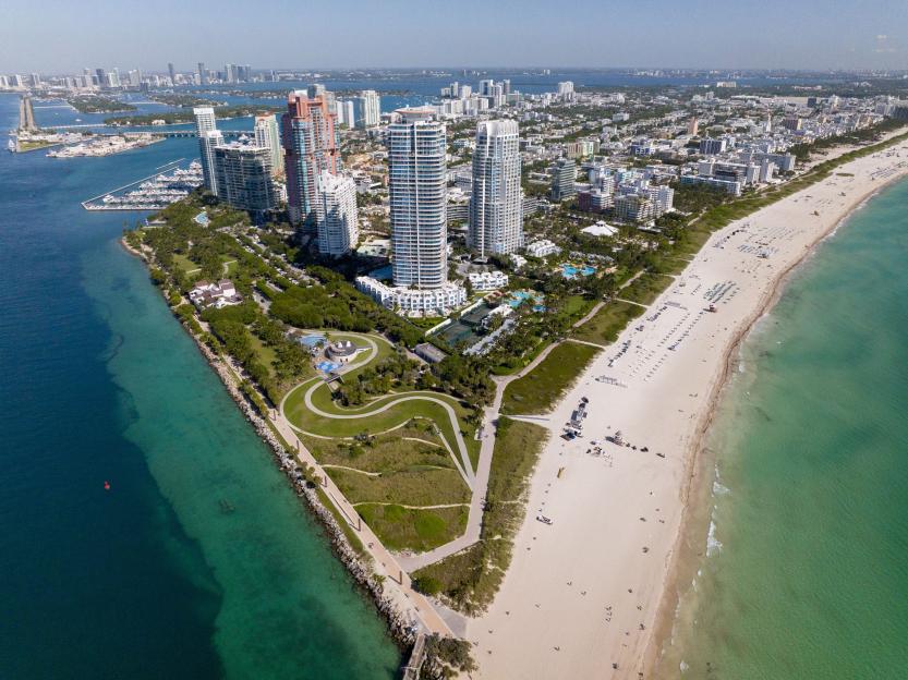 Aerial view of Miami Beach, Florida, showing the South Pointe Pier, beaches, turquoise water, skyscrapers, and cityscapes.