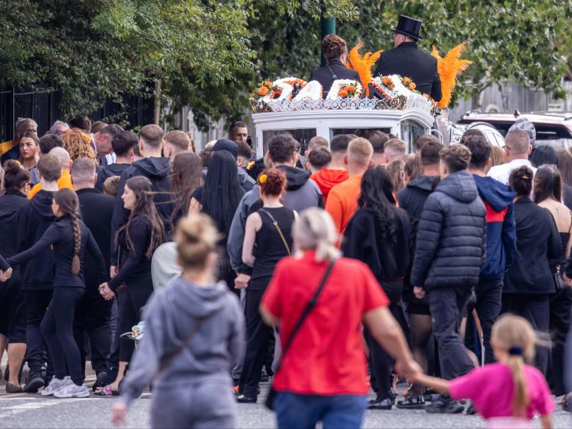 A large group of men, women, and children attend the funeral cortege for Jacob Matusiak.