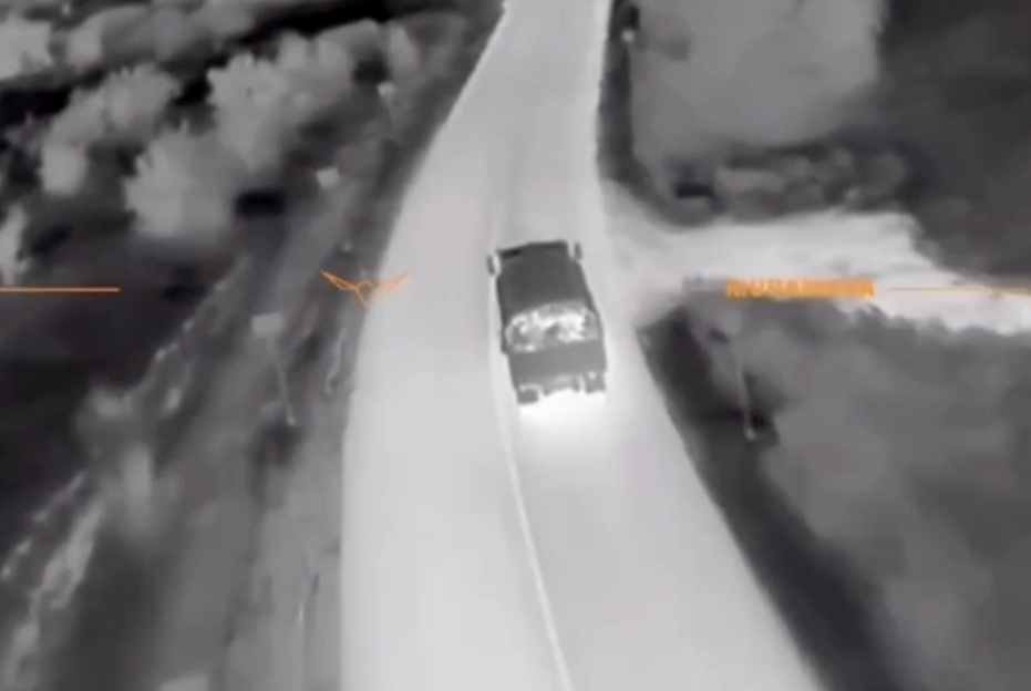 Thermal image of a truck driving on a road.