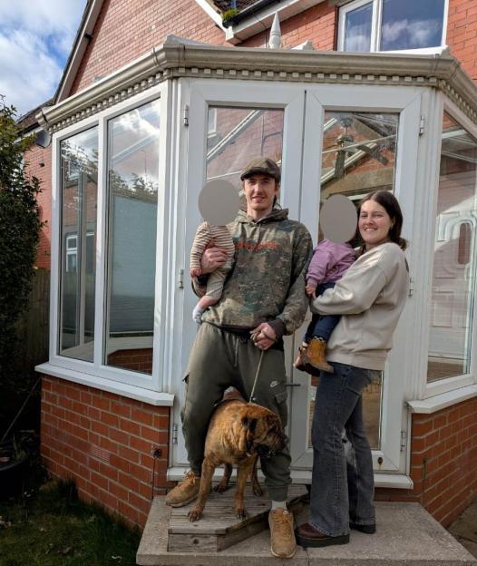 Tara Craven, Joseph, their two children, and their dog stand outside their semi-detached house after a lightning strike caused damage.