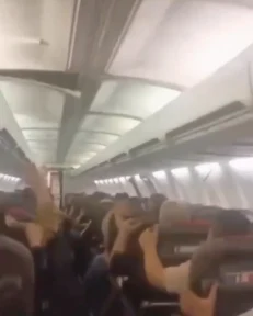 Terrifying moment plane cabin ceiling falls onto screaming passengers during chaotic landing after losing tyre