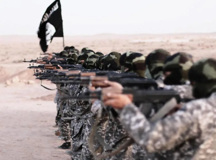 Islamic State of Iraq and the Levant propaganda photo showing masked militants firing weapons.