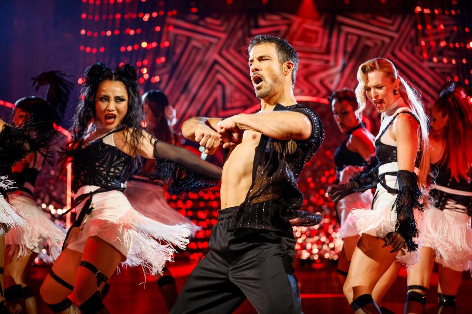 The Strictly Come Dancing 2025 Professional Dancers, including Ashley Roberts, Jay McGuiness, Layton Williams & Danny Mac, performing on stage.