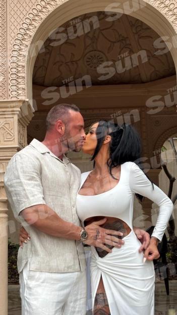 Katie Price and Lee Andrews kissing.