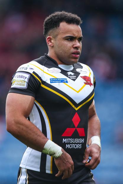 Rugby player Mason Caton-Brown wearing a black, white, and yellow jersey.