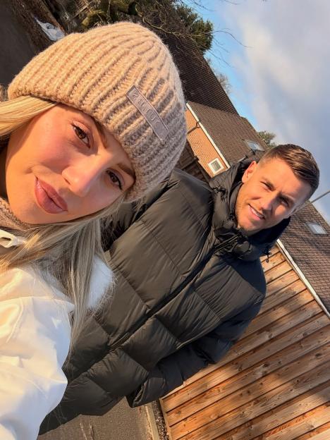 Holly Hagan and husband looking at the camera.