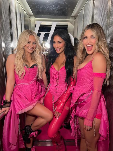 Three Pussycat Dolls in pink corsets and matching outfits.