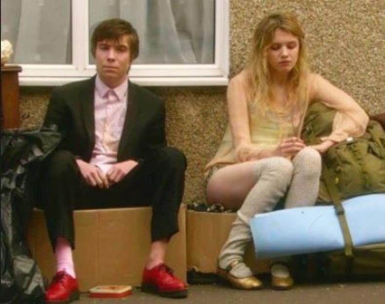 Hannah Murray and Joe Dempsie from Skins sitting on cardboard boxes.