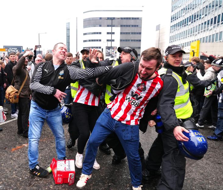 Police intervene as Newcastle United and Sunderland fans clash.