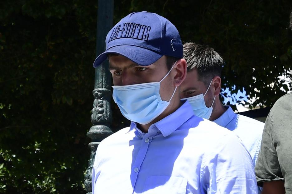 Harry Maguire leaving a court building in Greece, wearing a face mask and a cap.