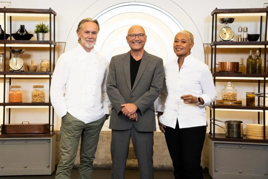 MasterChef: The Professionals judges Marcus Wareing, Gregg Wallace, and Monica Galetti standing together on set.
