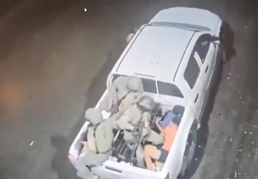 CCTV footage shows three soldiers forcing four boys into the back of a white pickup truck.