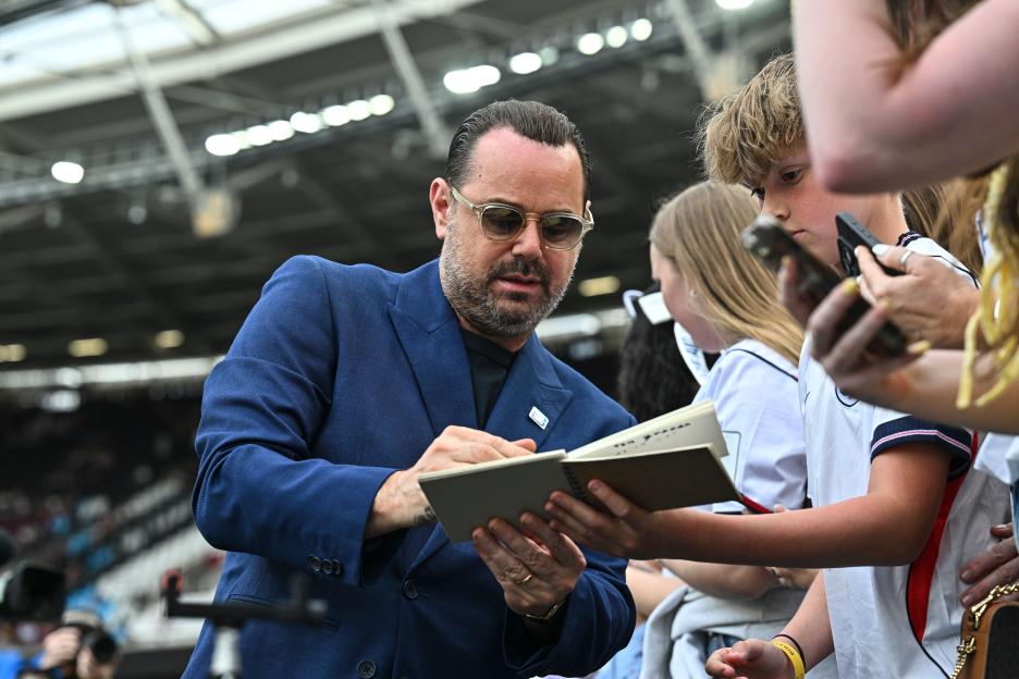 Danny Dyer signing an autograph for a fan at Soccer Aid for UNICEF 2026.
