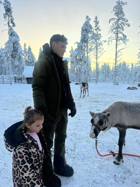 Phil Foden and his daughter in Lapland with reindeer.