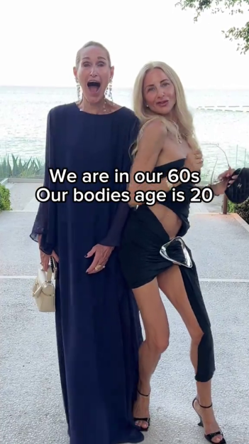 Two women in their 60s, dressed in formal wear, posing for a photo.
