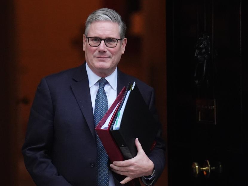 Prime Minister Sir Keir Starmer departing 10 Downing Street with two binders.