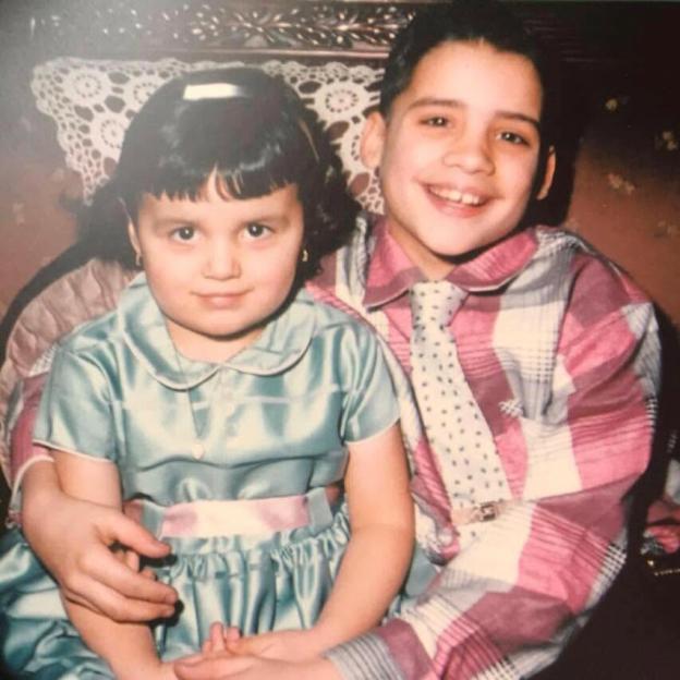 Young Diana and her brother smiling.