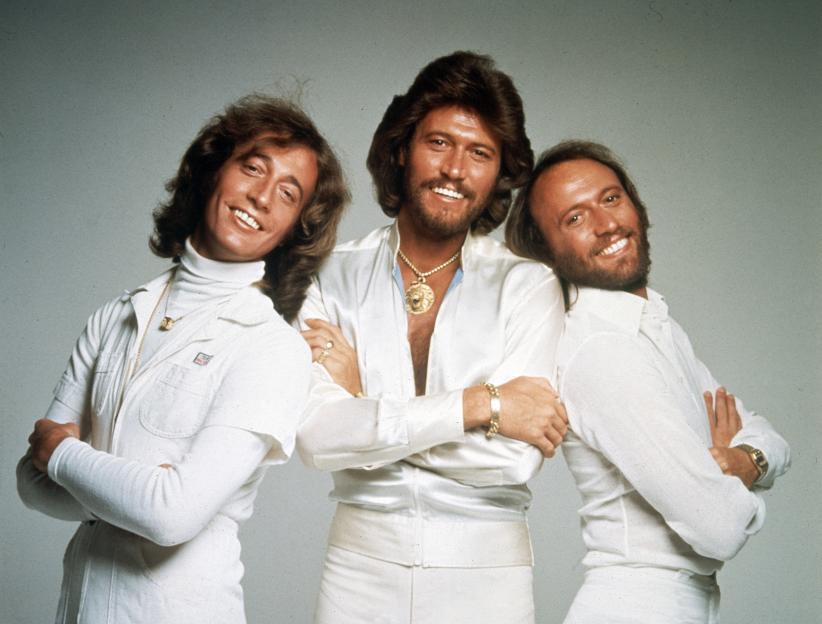 The Bee Gees, Robin Gibb, Barry Gibb, and Maurice Gibb, posing for a photo.