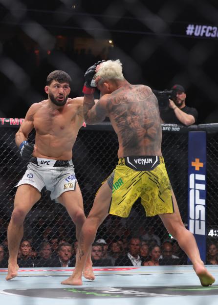 Charles Oliveira of Brazil exchanges strikes with Arman Tsarukyan in their lightweight fight.