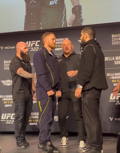 Two male UFC fighters face off at a press conference.